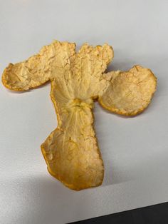 an orange peel is cut in half and placed on top of a white countertop