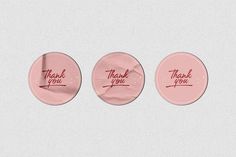 three pink buttons with thank you written on them