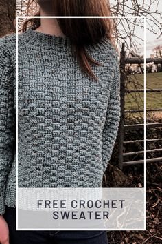 a woman standing in front of a fence wearing a blue sweater with the words free crochet sweater on it