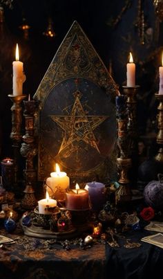 a table topped with lots of candles next to an ornate star sign and other decorations