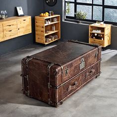 an old trunk is sitting in the middle of a room