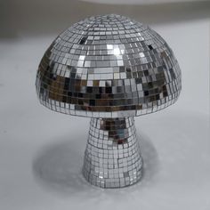 a shiny silver mushroom shaped object sitting on top of a table