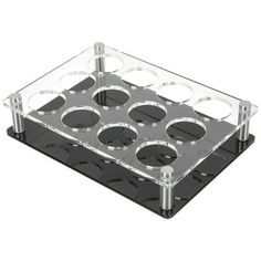 a clear plastic tray with six holes in the center and four metal knobs on each side