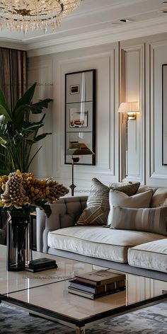 a living room filled with furniture and a chandelier