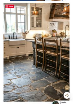 an image of a kitchen with stone flooring on the walls and in the center