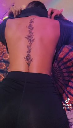 the back of a woman's body with flowers on it