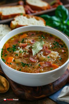 a white bowl filled with soup next to bread