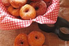 a basket filled with donuts next to a pair of scissors