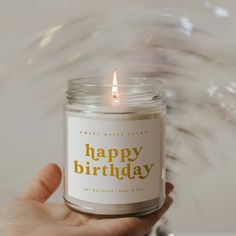 a person holding a candle with the words happy birthday on it