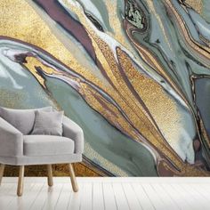 an abstract wallpaper with gold, blue and green paint on the walls in a living room