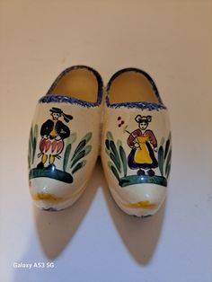 a pair of shoes with painted images on them