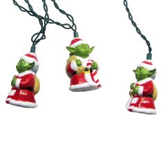 three christmas lights hanging from a string on a white background, one with an ornament in the shape of a santa clause