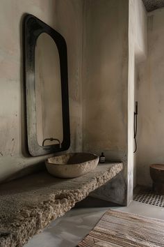 a bathroom with a sink, mirror and rug on the floor in front of it