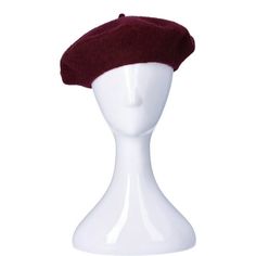 a white mannequin head with a red hat on it