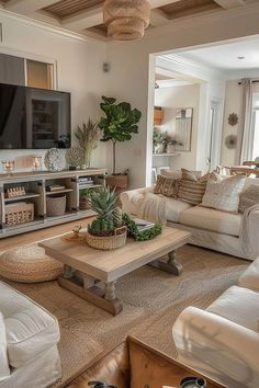 a living room filled with furniture and a flat screen tv on top of a wooden table