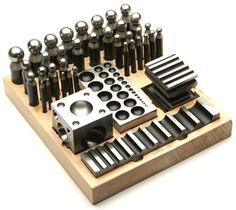 an assortment of tools are displayed on a wooden stand with holes and knobs in them