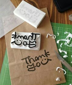 a brown paper bag sitting on top of a cutting board next to a pair of scissors