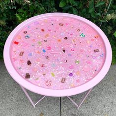 a pink table with lots of buttons on it