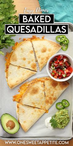 two quesadillas on a tray with salsa and avocado