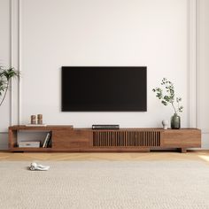 a flat screen tv mounted to the side of a wooden entertainment center in a living room