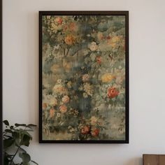 a painting hanging on the wall next to a potted plant