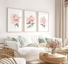 a living room filled with white furniture and flowers on the wall next to a window