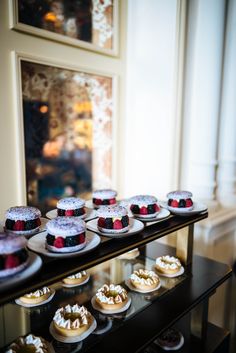 several desserts are displayed on the glass shelf