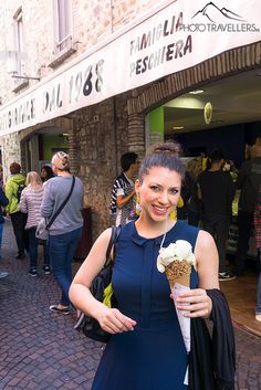 a woman in a blue dress holding an ice cream cone