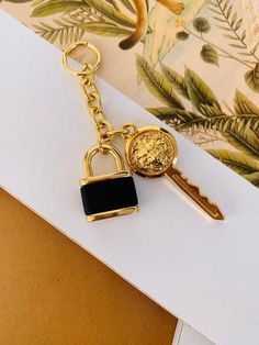 a gold key with a black padlock attached to it