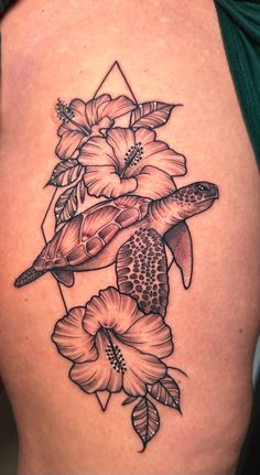 a woman's thigh with flowers and a turtle on it