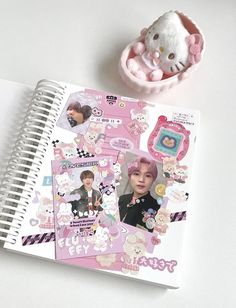 an open notebook with stickers on it next to a stuffed animal