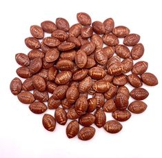 a pile of chocolate beans on a white background