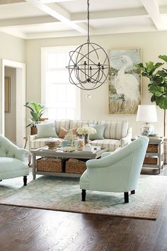 a living room filled with furniture and a chandelier hanging over it's head