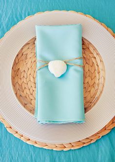 a place setting with blue napkins and a heart