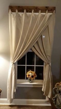 a window with curtains and sunflowers in it