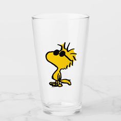 a glass with a cartoon character drawn on it