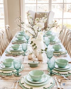 the table is set with dishes and place settings