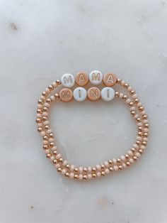 Angela Holm X Just Bead it by Rachel Treat yourself and your mini to the perfect accessory duo: Mama and Mini Neutral Bracelets! Whether you're rockin' a tan and white combo, complete with gold letter beads, or go for a classic 14k gold filled look – these one-of-a-kind bracelets from Angela Holm X Just Bead it by Rachel are exactly what you and your little one need to make a fashion statement any day of the week! This set comes with one Mama Bracelet and you can chose how many mini bracelets yo Mama Mini Bracelet, Diy Mama Bracelet, Mama And Me Bracelets, Mama Bracelet Beads, Mama And Mini Bracelets, Adjustable Rose Gold Jewelry With Letter Beads, Handmade Rose Gold Beaded Bracelets For Everyday, Dainty Adjustable Stretch Bracelet With Letter Beads, Adjustable Rose Gold Beaded Bracelet