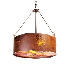 a light fixture with a bird hanging from it's center and leaves on the bottom