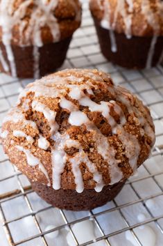 there are muffins with icing on the cooling rack