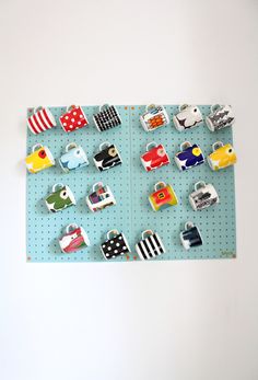 there are many magnets on the pegboard that is attached to the wall in this room