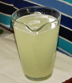 a glass filled with liquid sitting on top of a table