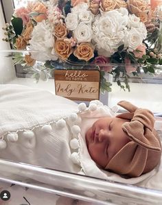 a baby is laying in a crib with flowers