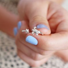 Adjustable sterling silver ring  	Turtle and starfish details  	Hypoallergenic              Product Information    This gorgeous little ring is a must-have jewellery gift for animal lovers, ocean lovers, and boho babes alike.    Made of hypoallergenic sterling silver, this stunning adjustable ring is a simple and stylish piece that can be slightly flexed to fit comfortably around your finger. At one open end sits a tiny turtle and at the other a starfish, giving this ladies' ring a bohemian ocea Silver Turtle Ring, Swimming Turtle, Turtle Ring, Lisa Angel, Turtle Jewelry, Tiny Turtle, Jewellery Gift