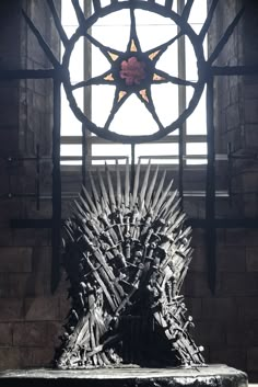 a woman sitting on top of a iron throne