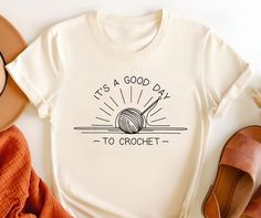 "Let this \"It's a Good Day to Crochet\" T-Shirt be your go-to for a boost of crafting cheer! With its sunny design and positive message, it's perfect for those who find joy in crochet hooks and yarn. This shirt is a great way to share your love for the hobby, and it's just as comfortable as it is inspiring. Whether you're working on your latest piece or simply enjoying the day, this tee is the perfect fit for a crochet lover's lifestyle. Add a little brightness to your wardrobe, or give it as a Sunshine Crochet, Crochet T Shirt, Knitting Shirt, Ladies Club, Message Positif, Crochet T Shirts, It's A Good Day, Crochet Shirt, Crochet Lovers