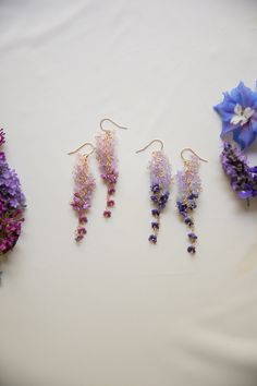 An absolutely beautiful pair of earrings, these earrings have over 50 tiny glass blown flowers that are perfectly placed to create a stunning gradient of petals that resemble the infamous wisteria flower. These earrings dangle beautifully in the sun. Like flowers, each pair of earrings are one of a kind! please allow for slight differences between pairs ! Part of the summer collection - limited stock.  D E T A I L S - 14k gold filled  - tiny 5mm glass blown flowers  - 14 gold filled accents. stamped for authenticity  - lightweight 4 grams for one ear.  - length is 3 inches from top of hook - Earring hook is gentle on the ears and feels secure.  ∙ EXTRAS  - Handcrafted with a lot of love.  - All of my jewelry arrives tightly wrapped.  - If this is a special gift or if you would like a custo Elegant Purple Pressed Flower Earrings, Delicate Purple Flower Earrings, Wisteria Jewelry, Wisteria Earrings, Wisteria Flower, Lilac Earrings, Gold Filled Earrings, Floral Earrings, Flower Jewellery