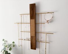 a wall mounted jewelry rack with several necklaces hanging on it