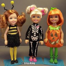 three dolls dressed in halloween costumes standing next to each other