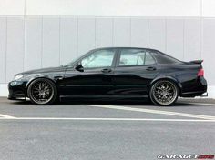 a black car parked in front of a building